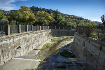 Fototapeta na wymiar Canalization of the river Riguel on its course through Uncastillo, Zaragoza, Aragon, eastern Spain