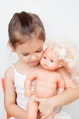 Little girl with a doll  - 142668236