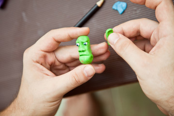 Modeling clay. Man sculpts from clay