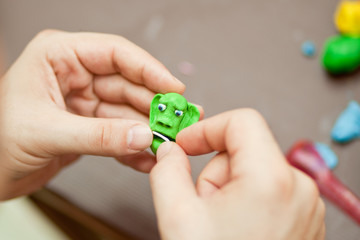 Modeling clay. Man sculpts from clay.