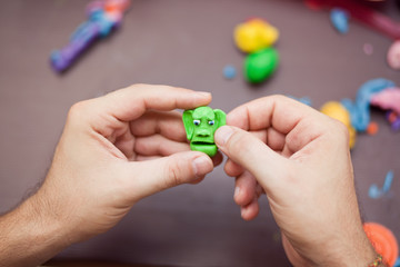 Modeling clay. Man sculpts from clay.