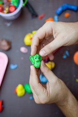 Modeling clay. Man sculpts from clay.