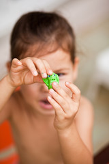 Little girl sculpts from clay 