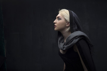 Girl in black on a black background