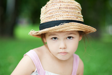 Girl in a straw hat in the park