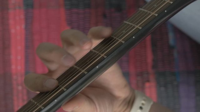 Guitar strings closeup. A man plays gitare