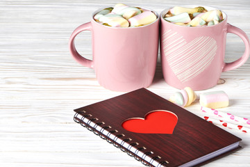 Two pink cup with hot cocoa and marshmallow