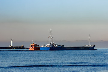 Blue cargo ship leaving Riga and entering Baltic sea