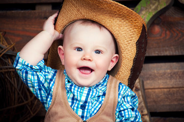 Portrait of a small boy in cowboy decor