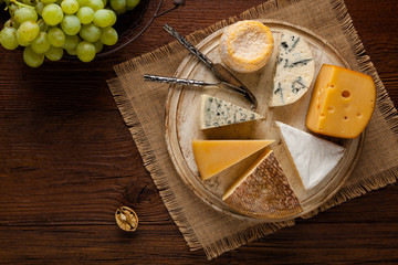 Mix cheese on wooden board.