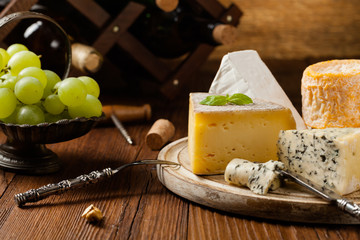 Mix cheese on wooden board.