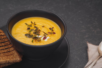 Pumpkin soup with blue cheese, thyme and slice of bread