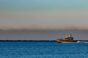 Fototapeta premium Orange pilot ship sailing from the Baltic sea in Latvia