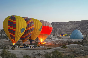 Obraz premium Colorful hot air balloons flying over the valley at Cappadocia, Turkey. Volcanic mountains in Goreme national park