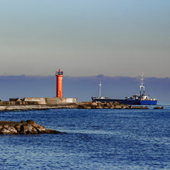 Blue cargo ship leaving Riga and entering Baltic sea
