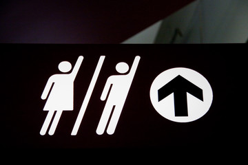 Sign with male and female silhouettes and up arrow