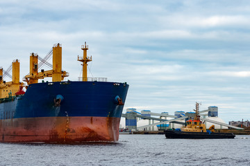 Blue cargo ship entering the port of Riga, Europe
