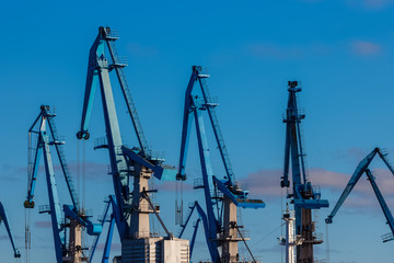 Fototapeta na wymiar Blue cargo cranes in the port of Riga, Europe