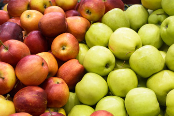 The counter with red and green apples on the market.