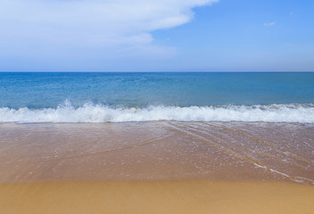 Beautiful white soft wave on empty tropical beach with blue sky background