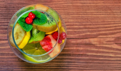 Delicious dessert with mint, cranberry and fresh fruit in a glass jar