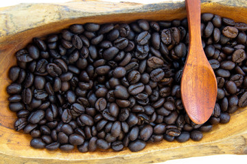 Fototapeta premium coffee beans in a wooden bowls, close up, horizontal