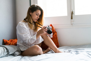 Girl setting camera on the bed
