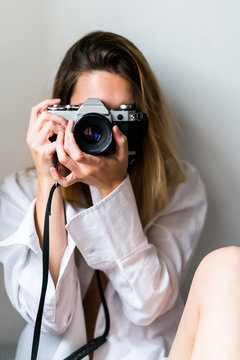 Young woman taking picture with camera
