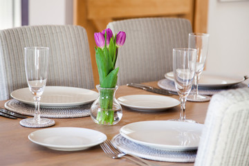 table setting with tulips in bright kitchen