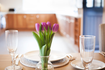 table setting with tulips in bright kitchen