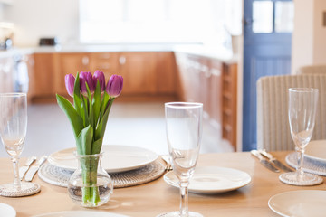 table setting with tulips in bright kitchen