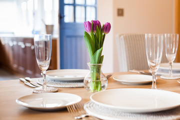 table setting with tulips in bright kitchen