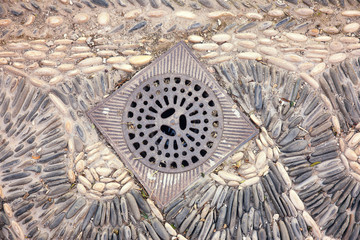 metal drain on typical stone pavement andalusian