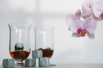 Stones for cooling whiskey and glases tulup on light wooden background