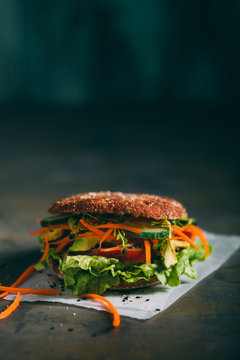 Vegetarian sandwich with lettuce, cucumber, carrot tomato anda avocado