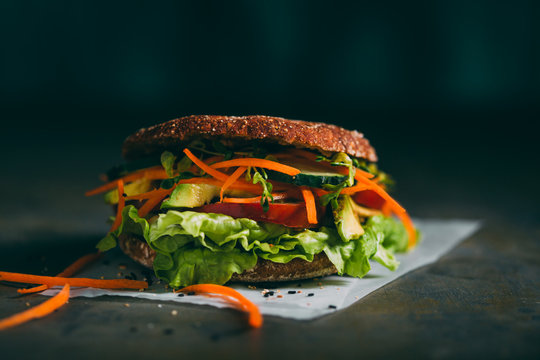 Vegetarian sandwich with lettuce, cucumber, carrot tomato anda avocado