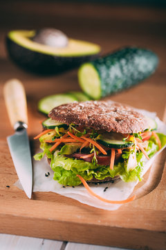 Vegetarian sandwich with lettuce, cucumber, carrot tomato anda avocado