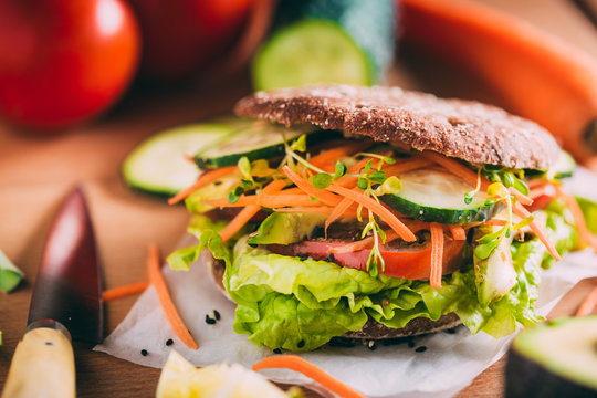 Vegetarian sandwich with lettuce, cucumber, carrot tomato anda avocado
