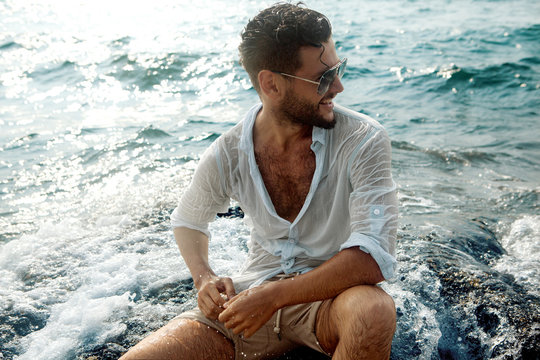 Smiling Guy In The Sea Spray On The Rocks