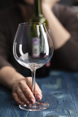 sad and wasted alcoholic woman sitting at home drinking red wine holding glass,  alcohol abuse