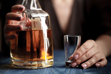 woman in depression, drinking alcohol on dark background