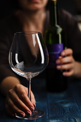 Drunk female with bottle of alcohol. Soccial issue alcoholism.