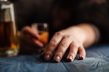 Drink responsibly. Portrait of drunk woman sitting atkitchen with his eyes closed