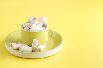 Twisted marshmallow on vibrant background, top view