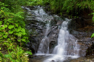 Fototapeta na wymiar Waterfall on mountain river in Carpathian Mountains , Romania