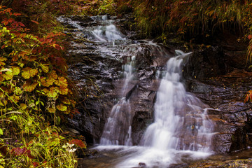 Waterfall on mountain river in Carpathian Mountains , Romania