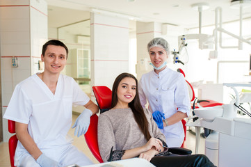 Portrait of dentists and happy girl.