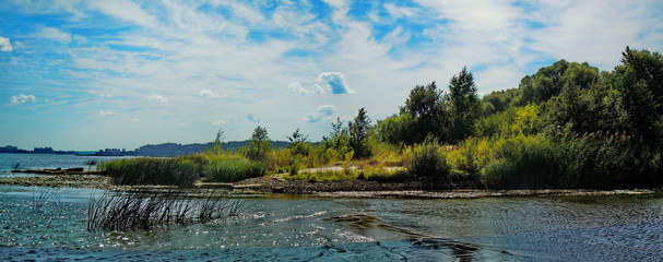 Panoramic view of grassy riverside