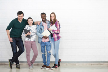 Group of youth adult multiracial college students reading and holding education books in the hands