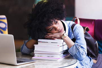 Young african american woman student tired of working and studying